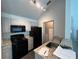 Efficient kitchen with stainless steel appliances, light countertops, and modern fixtures at 3337 Soho St # 205, Orlando, FL 32835