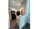Well-lit kitchen featuring black appliances, light countertops, and ceramic tile backsplash at 3337 Soho St # 205, Orlando, FL 32835
