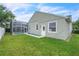 A spacious backyard with a screened-in pool and a well-maintained lawn at 339 Hammock Dunes Pl, Orlando, FL 32828