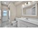 Well-lit bathroom with tile flooring, modern vanity, and shower with glass door at 339 Hammock Dunes Pl, Orlando, FL 32828