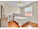 This bedroom features a ceiling fan, wood flooring, and a window for natural light at 339 Hammock Dunes Pl, Orlando, FL 32828