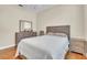 This bedroom features a wooden dresser, ceiling fan, wood flooring, and a comfortable bed at 339 Hammock Dunes Pl, Orlando, FL 32828