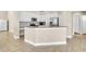 Stylish kitchen boasts white cabinets, granite countertops, stainless steel appliances, and tiled flooring at 339 Hammock Dunes Pl, Orlando, FL 32828