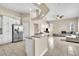 Bright kitchen with granite countertops and stainless steel appliances flows into a spacious living area at 339 Hammock Dunes Pl, Orlando, FL 32828