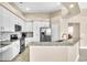 Modern kitchen features stainless steel appliances, granite counters, white cabinets, and tile backsplash at 339 Hammock Dunes Pl, Orlando, FL 32828