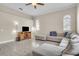 Bright living room features tile floors, a ceiling fan, and a comfortable sectional sofa with plush pillows at 339 Hammock Dunes Pl, Orlando, FL 32828