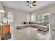 Spacious living room has large windows, tile flooring, and a sectional sofa, perfect for relaxing at 339 Hammock Dunes Pl, Orlando, FL 32828