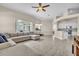 Open floor plan with tile flooring connects the living room, complete with sectional sofa, to the kitchen at 339 Hammock Dunes Pl, Orlando, FL 32828