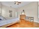 Bright main bedroom boasts hardwood floors, a ceiling fan, and a comfortable, inviting atmosphere at 339 Hammock Dunes Pl, Orlando, FL 32828