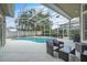 Relaxing screened-in pool area with patio seating and lush landscaping at 339 Hammock Dunes Pl, Orlando, FL 32828
