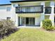 Backyard view of exterior with grass and greenery and a patio with sliding glass doors at 4405 S Semoran Blvd # 4, Orlando, FL 32822