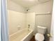 Bright bathroom with a white tiled shower-tub combination and tiled floors at 4405 S Semoran Blvd # 4, Orlando, FL 32822