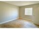Bedroom featuring tile flooring, neutral walls, and a window with blinds at 4405 S Semoran Blvd # 4, Orlando, FL 32822