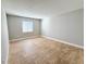 This large bedroom features tile floors, neutral walls, and a bright window at 4405 S Semoran Blvd # 4, Orlando, FL 32822