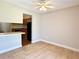 Bright condo dining area with tiled flooring and ceiling fan, seamlessly connecting to the kitchen and living spaces at 4405 S Semoran Blvd # 4, Orlando, FL 32822