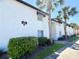 Well-maintained condo exterior featuring lush landscaping, palm trees, and clean white facade under clear blue skies at 4405 S Semoran Blvd # 4, Orlando, FL 32822
