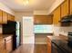 Efficient kitchen space showcasing essential appliances and wood cabinetry, maximizing functionality and style at 4405 S Semoran Blvd # 4, Orlando, FL 32822