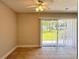 Bright living room with ceiling fan, tile flooring, and sliding glass doors to the outdoors at 4405 S Semoran Blvd # 4, Orlando, FL 32822