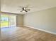 Open living room with tile flooring and sliding glass doors at 4405 S Semoran Blvd # 4, Orlando, FL 32822