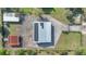 Birds-eye view of property showcasing a large barn with solar panels and multiple buildings on a spacious lot at 4640 Hickory Tree Rd, St Cloud, FL 34772
