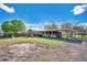 Wide backyard with large lawn, a play set, and a covered patio at 4640 Hickory Tree Rd, St Cloud, FL 34772