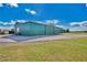 Large, metal barn with an overhanging roof area and a grassy area, perfect for a rural property at 4640 Hickory Tree Rd, St Cloud, FL 34772