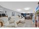 Basement room with carpet, a white sofa, a desk, and a television at 4640 Hickory Tree Rd, St Cloud, FL 34772