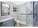 Bathroom featuring a shower, toilet, gray vanity, and mirror at 4640 Hickory Tree Rd, St Cloud, FL 34772