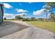 Exterior shot showing gravel drive and green grass at 4640 Hickory Tree Rd, St Cloud, FL 34772
