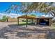 Exterior of property with a covered parking area, shipping containers and a play set at 4640 Hickory Tree Rd, St Cloud, FL 34772