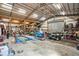 Inside a large metal barn with a high ceiling, a car lift, shelving and other garage equipment at 4640 Hickory Tree Rd, St Cloud, FL 34772