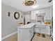 Bright kitchen featuring white cabinets and a farmhouse sink with an island at 4640 Hickory Tree Rd, St Cloud, FL 34772