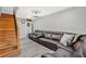 Living room area features wood flooring and a large sofa with a wooden staircase at 4640 Hickory Tree Rd, St Cloud, FL 34772