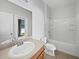 Bright bathroom with a vanity, toilet, and bathtub featuring a showerhead at 4841 Hickory Stream Ln, Mulberry, FL 33860