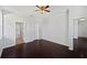 Large bedroom with dark hardwood floors, featuring neutral walls and ceiling fan at 4841 Hickory Stream Ln, Mulberry, FL 33860