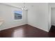 Bright dining room featuring hardwood floors, a chandelier, and a large window at 4841 Hickory Stream Ln, Mulberry, FL 33860