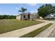 Charming one-story home boasting a two-car garage, landscaping, and an expansive front lawn at 4841 Hickory Stream Ln, Mulberry, FL 33860