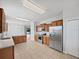 Well-equipped kitchen with stainless steel appliances and wooden cabinets overlooking the dining area at 4841 Hickory Stream Ln, Mulberry, FL 33860