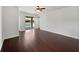 Spacious living room with hardwood floors and sliding glass doors leading to a patio at 4841 Hickory Stream Ln, Mulberry, FL 33860