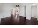Inviting living room with hardwood floors, a ceiling fan, and an open layout to the kitchen at 4841 Hickory Stream Ln, Mulberry, FL 33860