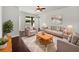 Comfortable living room with dark wood floors, neutral colors, and large windows with beautiful views at 4841 Hickory Stream Ln, Mulberry, FL 33860