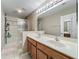 Bright bathroom features a double sink vanity and glass enclosed shower with tiled surround at 5050 Shorewood Landing Ln, Oviedo, FL 32765