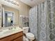 Hall bathroom with patterned shower curtain and neutral-toned walls at 5050 Shorewood Landing Ln, Oviedo, FL 32765