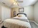 Cozy bedroom boasts wood-look floors, neutral walls, ceiling fan, and a closet for storage at 5050 Shorewood Landing Ln, Oviedo, FL 32765