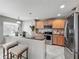 Well-equipped kitchen with stainless steel appliances and a breakfast bar at 5050 Shorewood Landing Ln, Oviedo, FL 32765