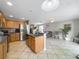 Bright kitchen open to living area, showcasing stainless appliances and tile flooring at 5050 Shorewood Landing Ln, Oviedo, FL 32765