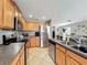 Open kitchen with stainless steel appliances, granite countertops, and tile floors at 5050 Shorewood Landing Ln, Oviedo, FL 32765