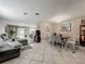 Open-concept living and dining area with stylish furnishings and tile floors at 5050 Shorewood Landing Ln, Oviedo, FL 32765