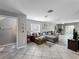 Spacious living room featuring tile flooring, a comfortable sofa, and natural light at 5050 Shorewood Landing Ln, Oviedo, FL 32765