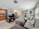 Open-concept living room with a sofa, TV, and view into kitchen and dining area at 5050 Shorewood Landing Ln, Oviedo, FL 32765